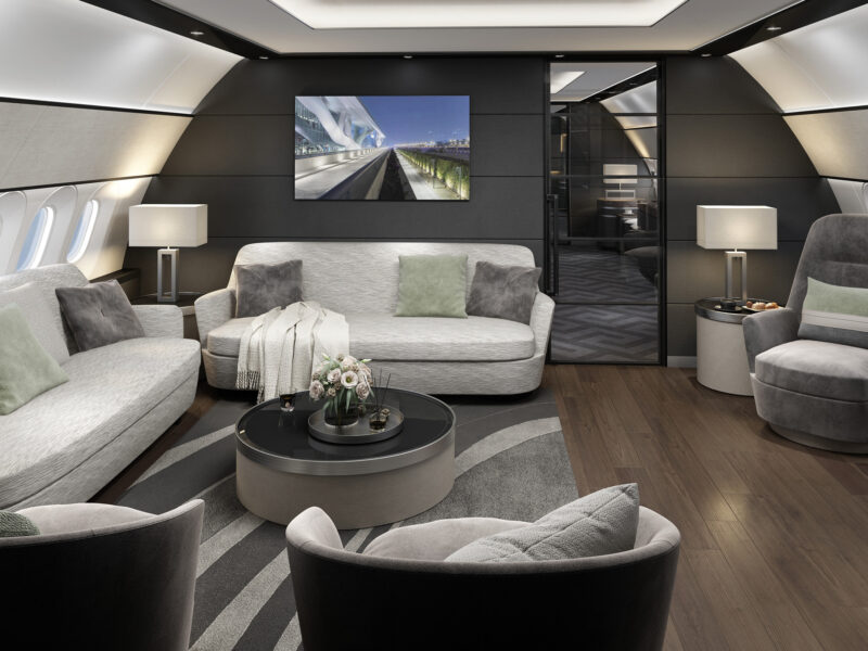 Spacious VIP lounge area in Airbus A340 business jet with modern seating and ambient lighting