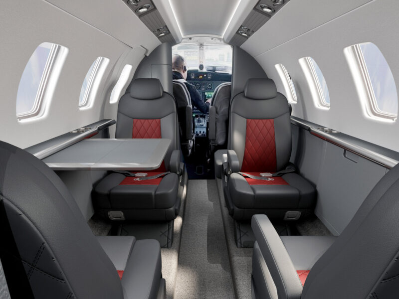 3D rendering of Cessna Citation CJ1 private jet interior, view facing cockpit with leather seating and table